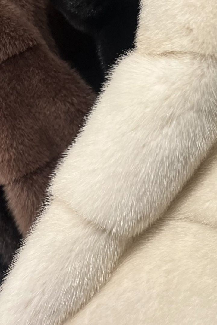 Macro shot of white and brown mink fur panels showing texture and color contrast.